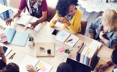 Small group business workshop for women, mid-discussion around one table