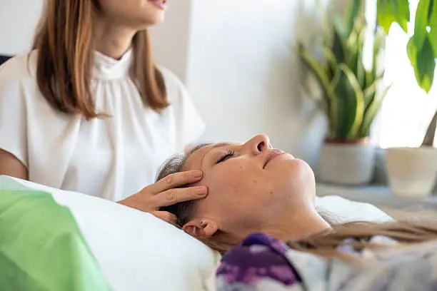 A wellness practitioner working with a client in her own treatment room